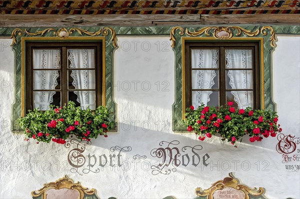 Typical Lüftlmalerei around window with geraniums, Wallgau, Werdenfelser Land, Upper Bavaria,