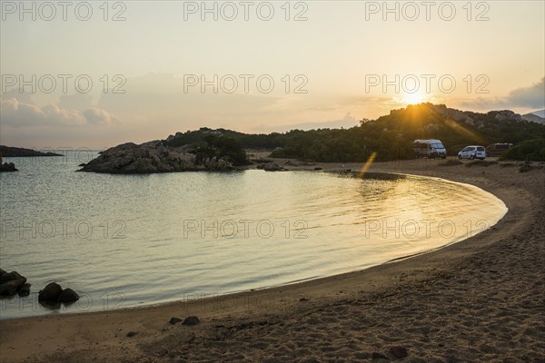 Lonely beach with granite rocks and campers, wild campsite, sunrise, Spiaggia Poltu Manzu, Capo