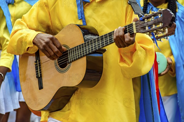 Guitarist playing his instrument during a popular religious festival in the state of Minas Gerais,
