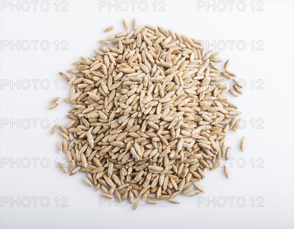 Heap of rye grains isolated on white background. close up, top view