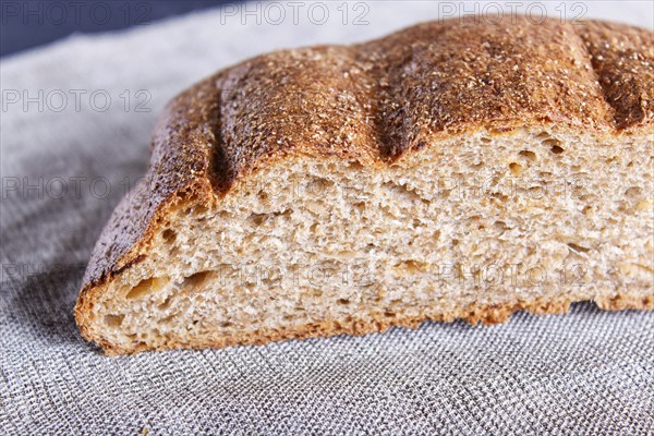 Cut buckwheat bread on linen napkin. close up