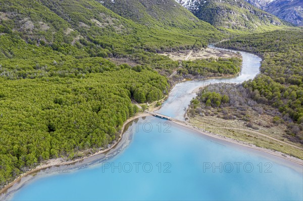 Aerial view of lake Lago Jeinimeni, river flowing out of the lake, glacial blue water in contrast