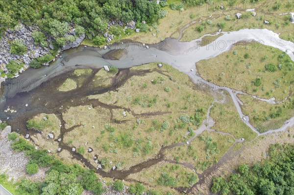 Aerial view of a small river along road Aursjovegen, a rural tourist route in the northern fjord