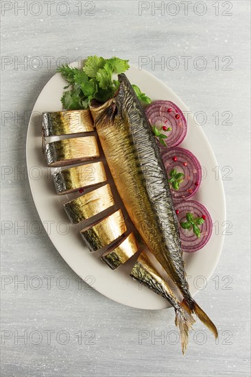 Smoked mackerel, top view, with spices, on a wooden table, no people, selective focus