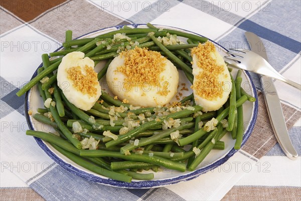 Swabian cuisine, yeast dumplings with green beans, breadcrumbs, served on a plate, typical Swabian,
