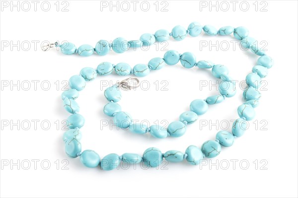 Blue semiprecious stone beads isolated on white background. top view, close up