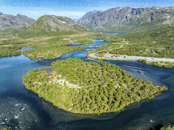Islands in river Sjoa, famous Besseggen ridge in the back, road to Gjendesheim tourist hut, aerial