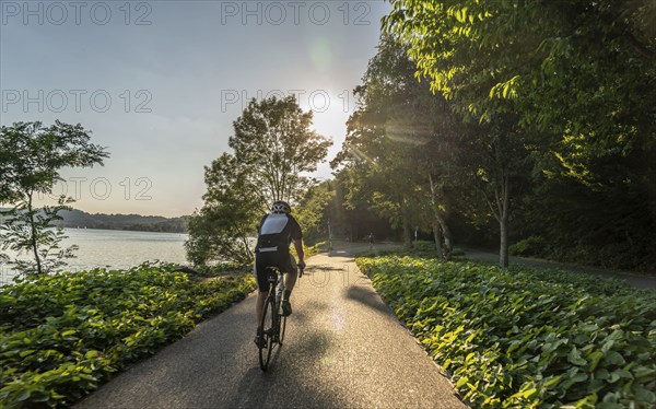 Cycling on Lake Baldeney, around 14 kilometres around the Ruhr reservoir, summer evening on the