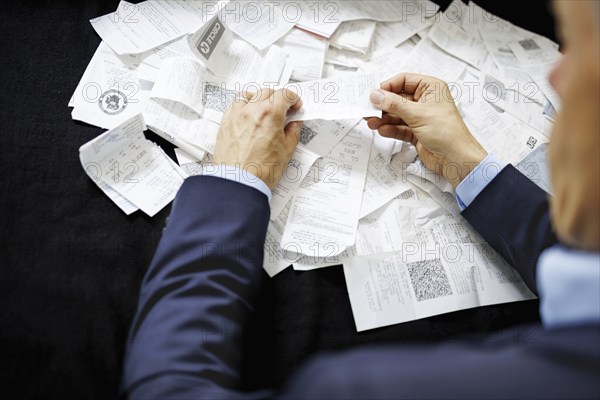 The subject of taxes. A man holds receipts in his hand in Berlin, 09/08/2024