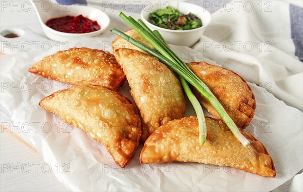 Fried chebureks, close-up, on a light background, no people