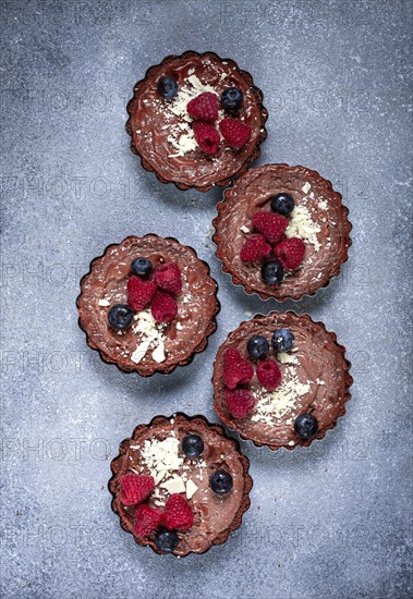 Chocolate tartlets, stuffed with cottage cheese and berries, breakfast, homemade, no people