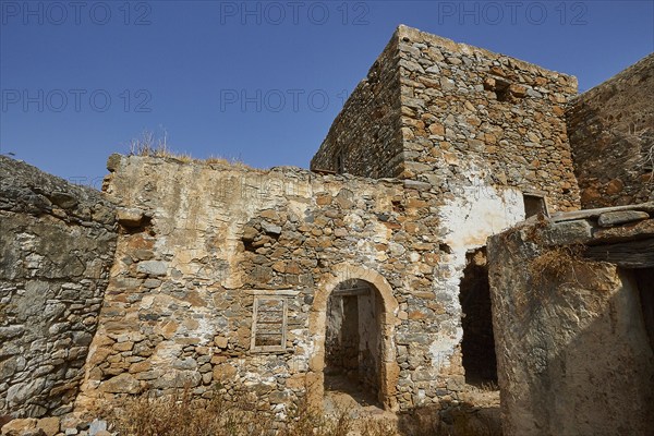 Abandoned stone houses and ruins under a clear blue sky on a sunny day, Venetian Sea Fortress,