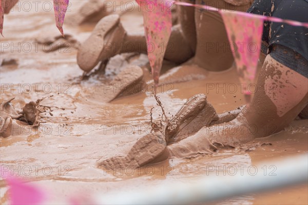 Shoes in the mud during a dynamic outdoor obstacle course