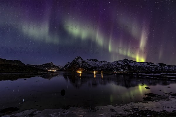 Northern lights over fjord, steep mountains, winter, aurora borealis, Flakstadoya, Lofoten, Norway,