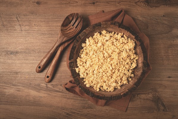 Cooked couscous, in a wooden bowl, top view, no people