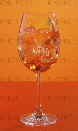 Aperol Spritz in front of an orange background