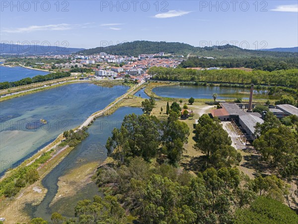 Aerial view of a peaceful natural environment with river, hills, forests and a small town in the
