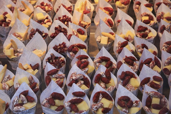 Cheese and small sausages packed for sale, Mercado San Miguel market, Madrid city centre, Spain,