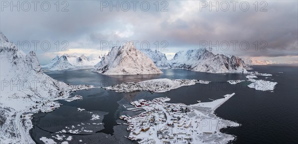 View of snow-covered islands, fjord and mountains, fishing villages Sakrisøy and Reine, Reinefjord,