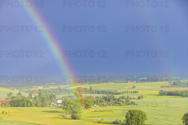 Thunderstorm cell with rainbow over fields near Krebs in the Osterzgebirge, Krebs, Saxony, Germany,