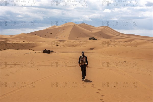 Hiking up the Great Dune of Merzouga in the Erg Chebbi desert, Moroccan Sahara desert