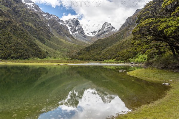 Tranquil mountain lake Mackenzie at the famous Routeburn Track, Fiordland National Park, South