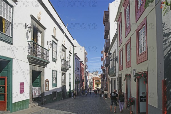 Lively street in an old town with historic facades under a blue sky, Santa Cruz de la Palma, La