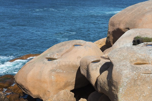 Close-up of jagged rocks with a view of the blue water, Ploumanac'h, Ploumanach, Perros-Guirec,