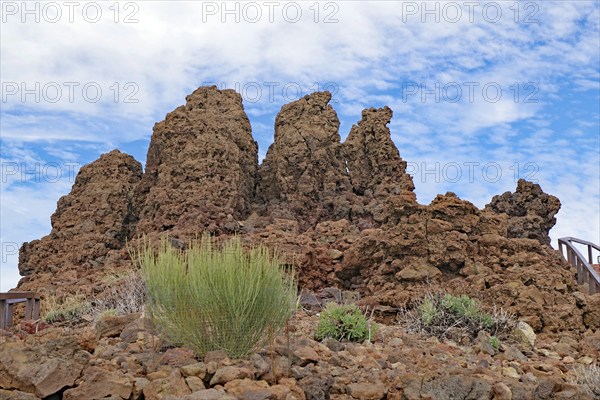 Brown rocks rise into a cloudy desert landscape, Roques de los Muchachos, La Palma, Canary Islands,