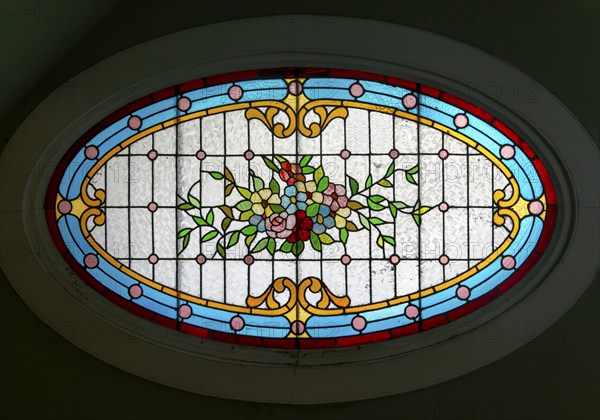 Stained glass oval window inside Casa Molina, Museo de Arte Popular de Yucatan, Merida, Mexico,