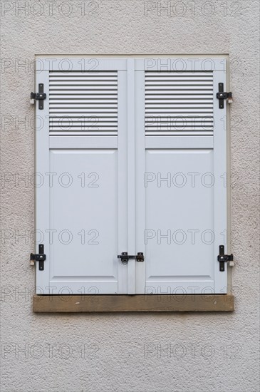 Windows with grey metal shutters