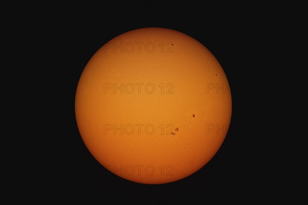 A view of the suns with spots and structure through a telescope