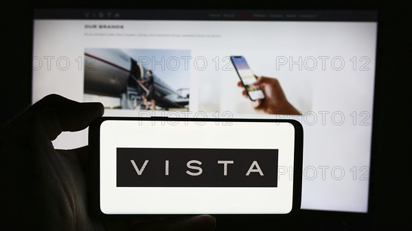 Stuttgart, Germany, 07-11-2024: Person holding cellphone with logo of Emirati aviation company