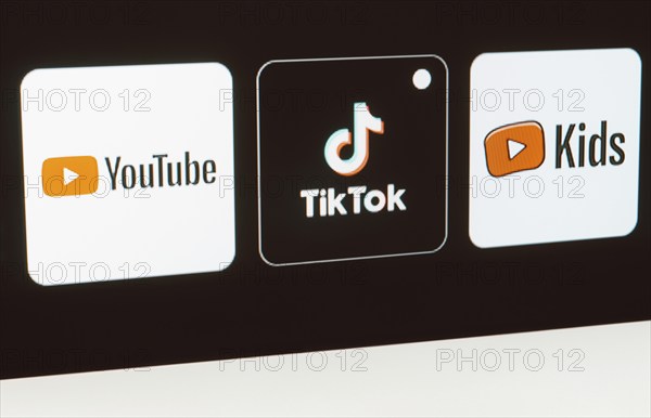 In this photo illustration the YouTube, TikTok, YouTube Kids logo is displayed on a TV screen