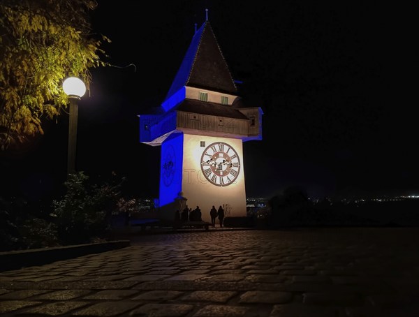 The famous Clock Tower (Grazer Uhrturm) on Shlossberg hill, Graz, Styria region, Austria, by night,