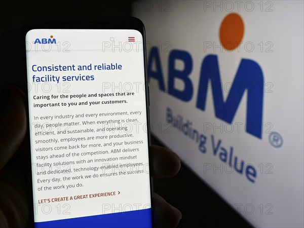 Stuttgart, Germany, 03-13-2024: Person holding mobile phone with web page of US facility management