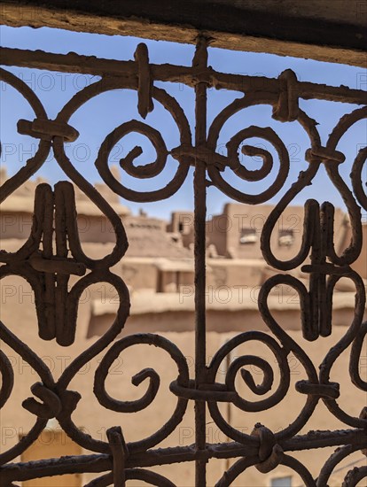 Ornate traditional window grid of a berber house ruin in the city center of Amezrou, Morocco,