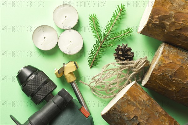 DIY Christmas candle holder made of pine logs, candles, craft rope, fir branches and cones. Layout