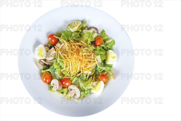 A plate featuring a Cobb Salad with a medley of fresh ingredients, including lettuce, mushrooms,