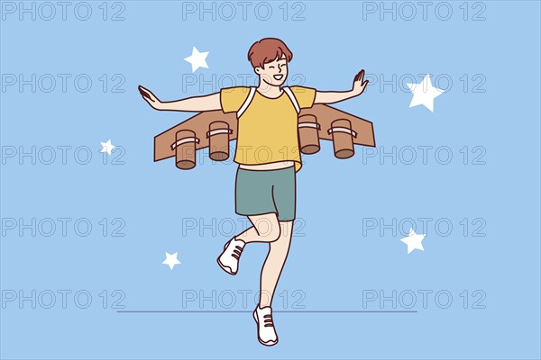Little boy dreams of becoming pilot or astronaut and jumps in suit with airplane wings. Cheerful