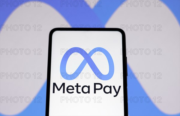In this photo illustration the Meta Pay logo seen displayed on a smartphone and in the background