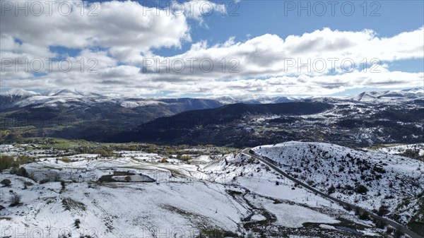 Bright panoramic view of a snow-covered mountainous region with a winding road. Posof, Ardahan,