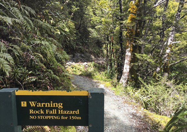 Warning sign about falling rock at famous Routeburn Track, South Island of New Zealand