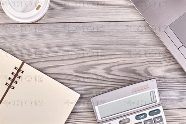 Calculator with blank notepad and copy space. White wood background
