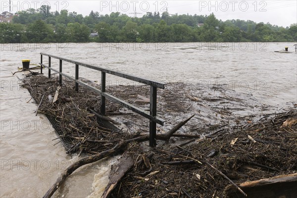 Symbolic image extreme weather, global warming, climate change, flood, washed up wood, footbridge,