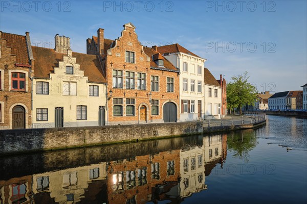 Typical Belgian cityscape Europe tourism concept, canal and old houses on sunset. Bruges (Brugge),