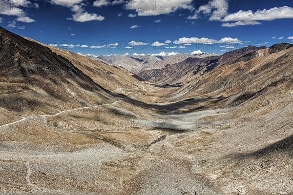 View of Karakoram range and road in valley from Kardung La, the highest motorable pass in the world