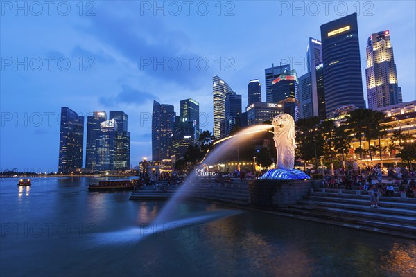 SINGAPORE, JANUARY 1, 2014: Night view of Singapore Merlion at Marina Bay against Singapore skyline