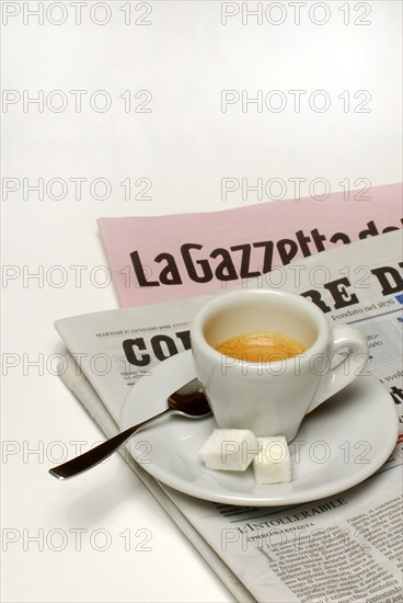Cup of espresso with sugar on newspaper, household sugar, sugar cubes, coffee