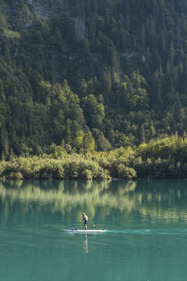 Stand-up paddler on Lake Klöntal, Canton Glarus, Switzerland, Europe